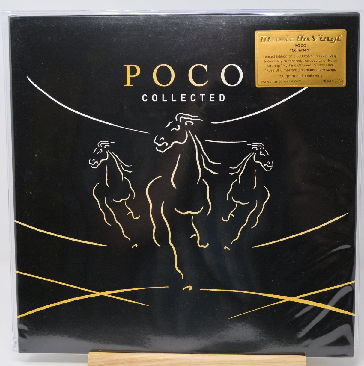 Poco Collected vinyl record album cover on a black background with gold line art of three horses and a gold sticker in the top right corner.