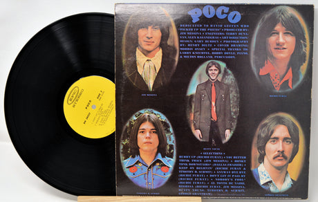 Vinyl record with its cover featuring band members' portraits and album text.