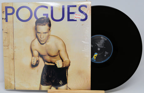 Vinyl record with a cover featuring a boxer and 'Pogues' text on a white background
