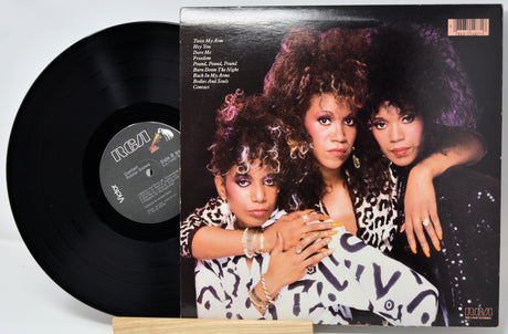 Vinyl record with a cover featuring three women, likely from a music album.