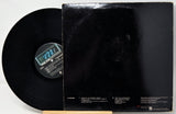 A black vinyl record partially pulled from its black sleeve, photographed against a plain white background. The center label shows the brand name Polydor.