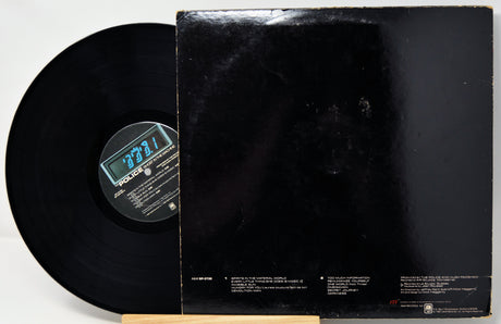 A black vinyl record partially pulled from its black sleeve, photographed against a plain white background. The center label shows the brand name Polydor.