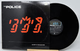 Vinyl record with digital clock display and 'The Police' album cover