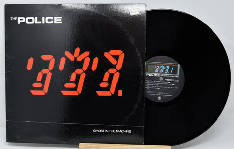 Vinyl record with digital clock display and 'The Police' album cover