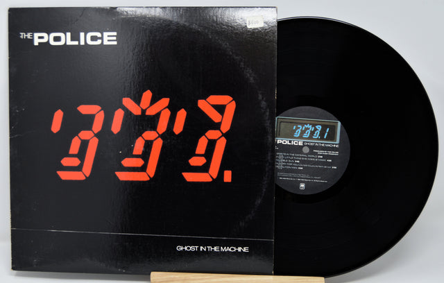 Vinyl record with digital clock display and 'The Police' album cover