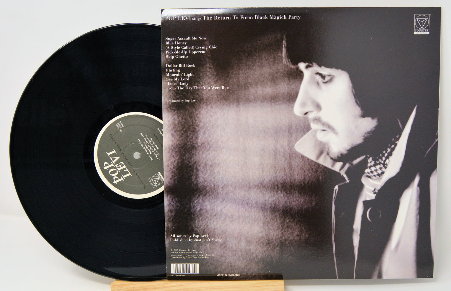 Back cover and vinyl of Pop Levi's The Return To Form Black Magick Party LP with tracklist