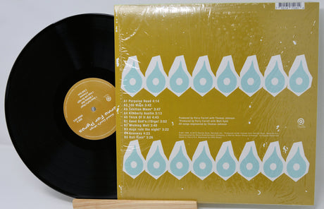 Vinyl record with a yellow cover featuring blue geometric patterns on a light gray background