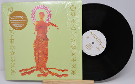 Vinyl record with a colorful cover featuring a stylized figure on a light gray background
