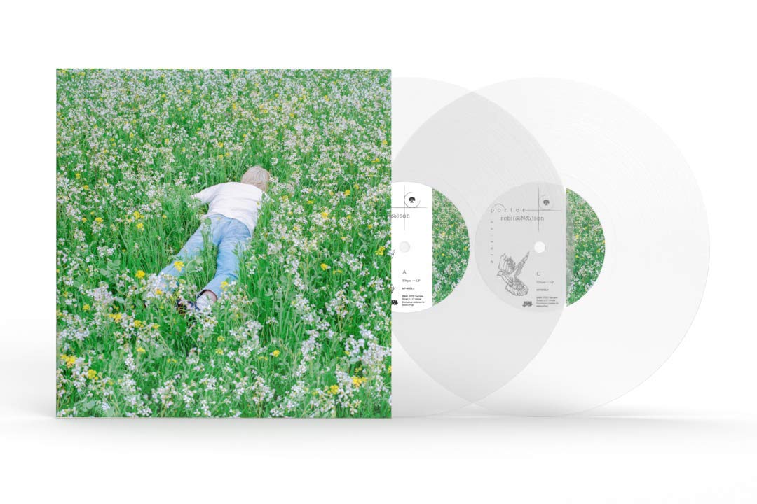A square album-style cover showing a child lying in a green flower field, with two translucent clear vinyl records partially visible behind it on a white background.