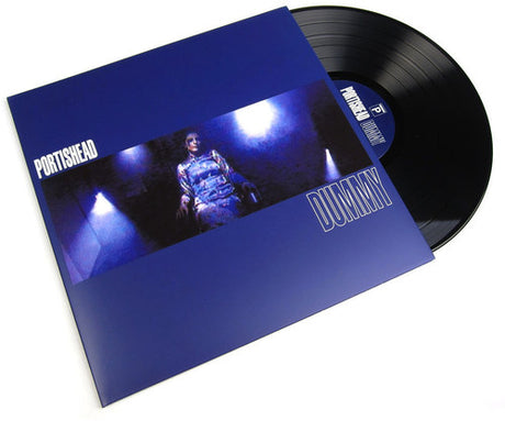 Vinyl record and cover with the album title 'Dummy' by Portishead printed on it. The cover is predominantly blue with a picture of a person in the background.