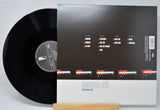 Vinyl record 'Portishead - Roseland NYC Live' with back cover displaying track listings on a white background