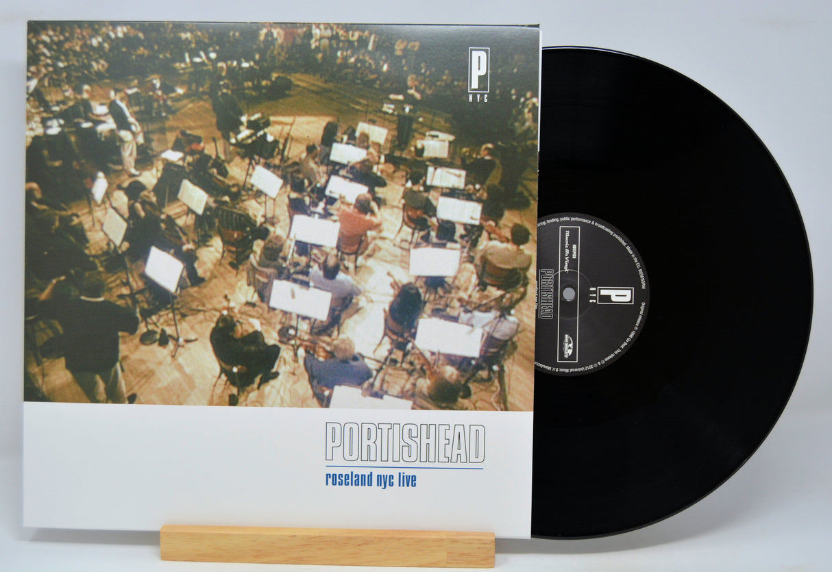 Vinyl record and cover with 'Portishead, Roseland NYC Live' album art on a white background