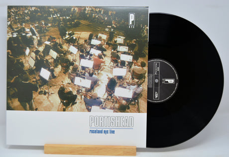 Vinyl record and cover with 'Portishead, Roseland NYC Live' album art on a white background