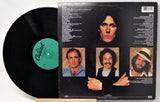 Vinyl record with a black cover featuring portraits of a person and text.