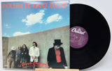Vinyl record with 'Pousette Dart Band' album cover showing a group of people against a blue sky.