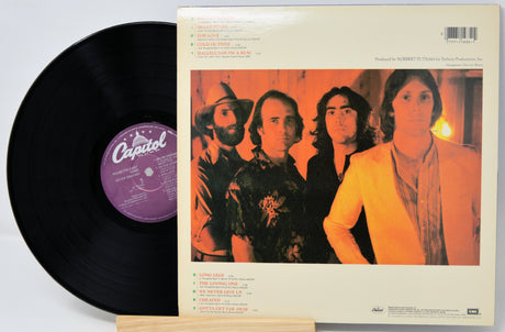 Vinyl record with a Capitol label and a cover featuring four band members.