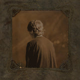 Sepia-toned album cover featuring a person with their back turned, surrounded by ornate vintage framing
