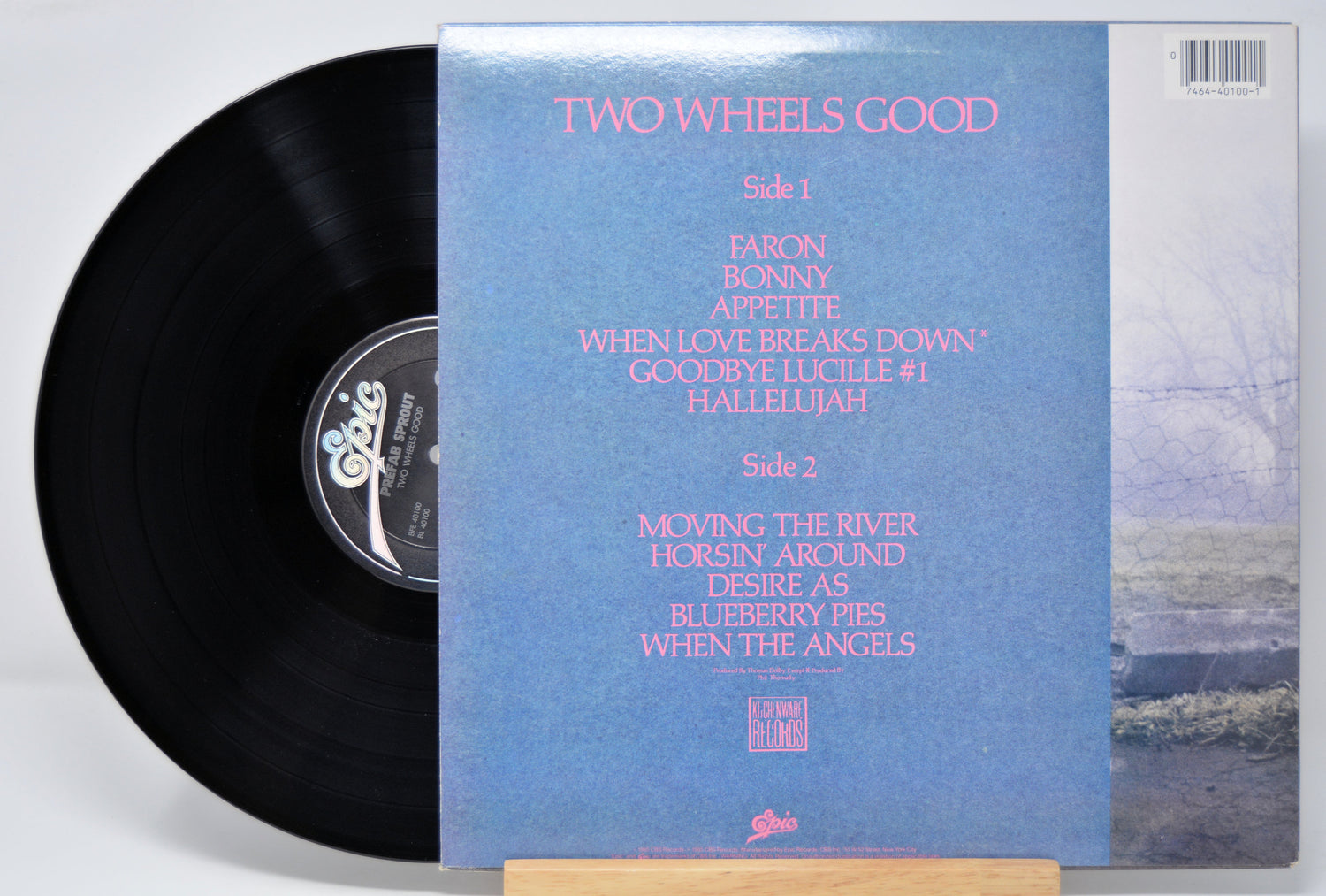 'Prefab Sprout Two Wheels Good' Vinyl record with blue back cover featuring text and a scenic illustration.