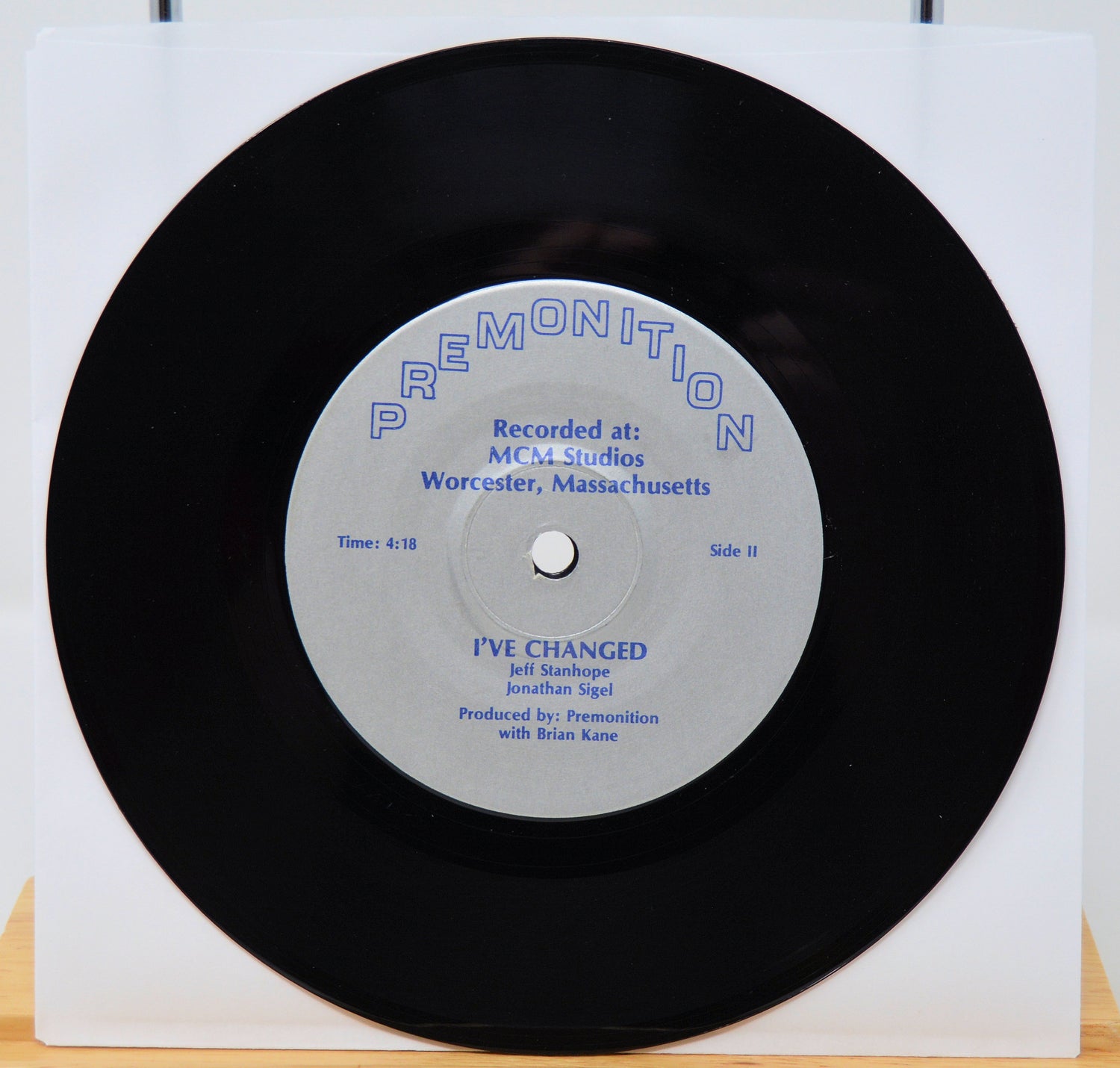 Vinyl record with a white label on a white background featuing I've changed