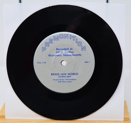 Vinyl record with a white label on a white background featuring Brand New World 