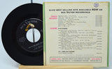 Vinyl record with RCA Victor sleeve listing Elvis Presley's hits on a light blue background