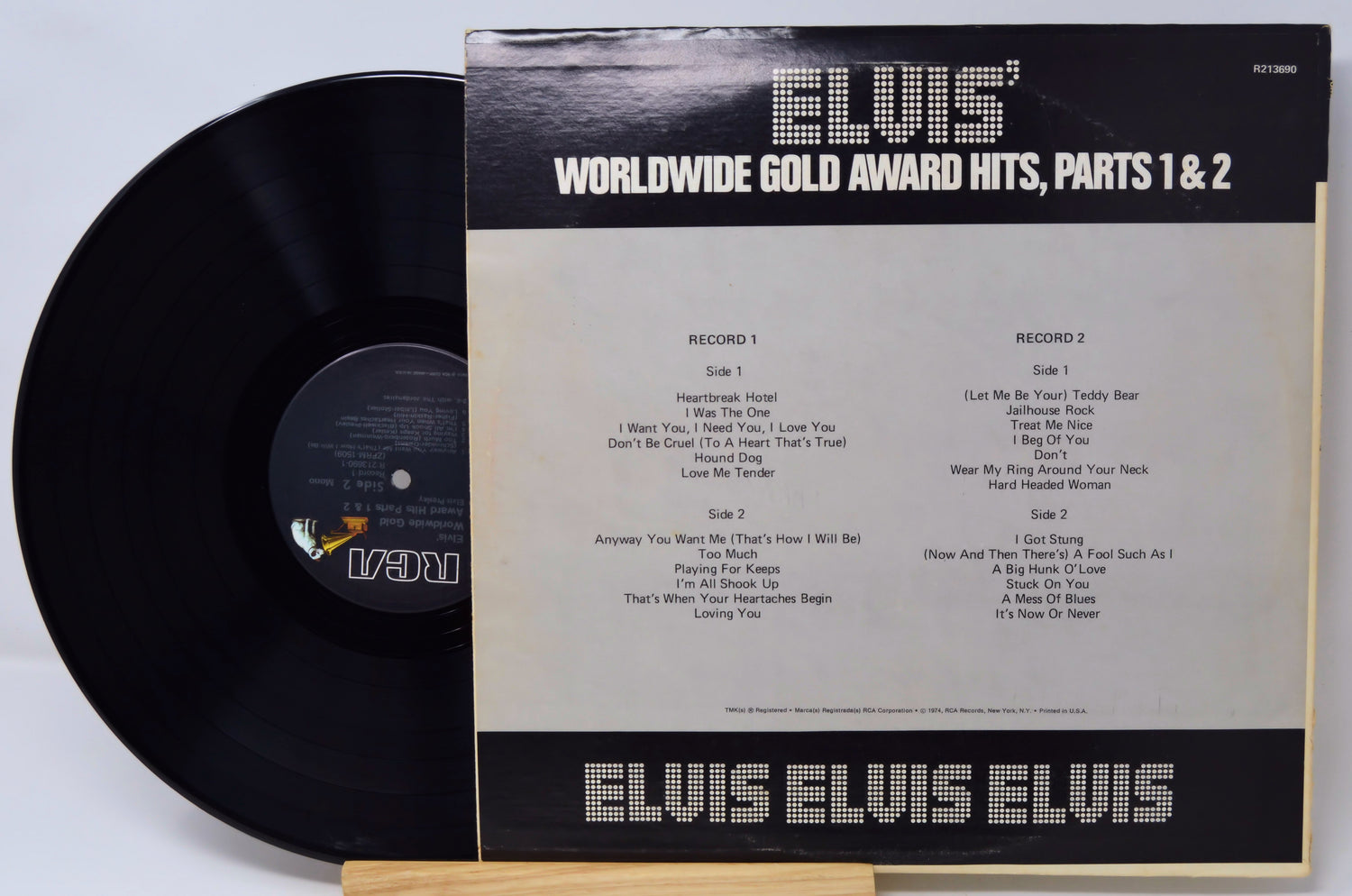 Vinyl record with 'Elvis' Worldwide Gold Award Hits, Parts 1 & 2' cover on a light gray background