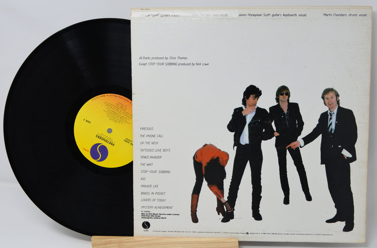 Vinyl record with a cover featuring four people and a yellow label.