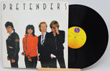 Vinyl record with cover featuring four band members and 'Pretenders' album text.