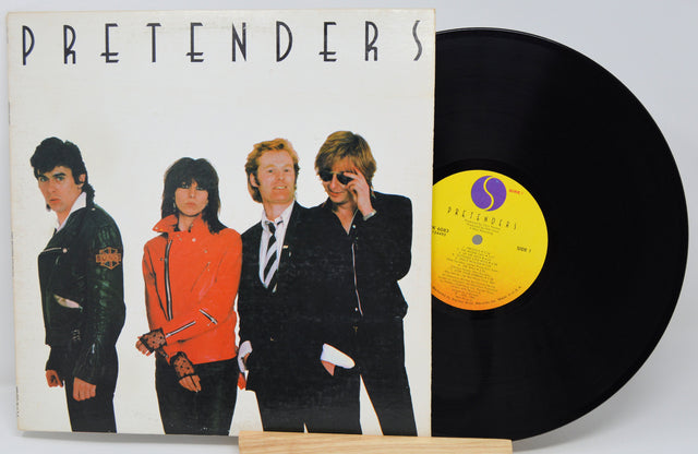 Vinyl record with cover featuring four band members and 'Pretenders' album text.