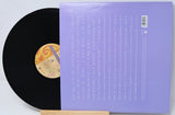 Vinyl record with a purple cover on a white background