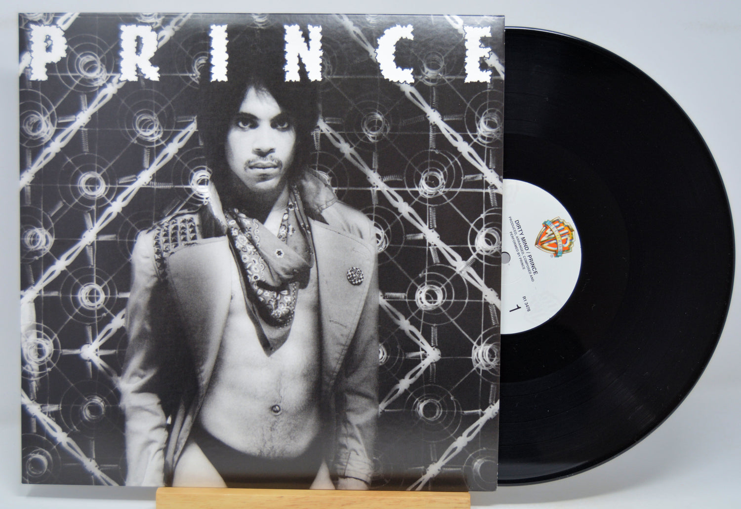 Vinyl record with a cover featuring a person and the word 'PRINCE'.