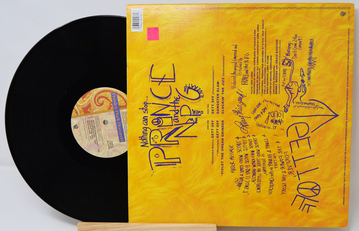 Vinyl record with yellow cover featuring text and graphics, on a white background