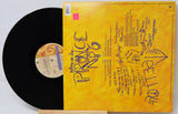 Vinyl record with yellow cover featuring text and graphics, on a white background