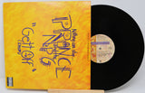 Vinyl record with a yellow cover featuring text and a black record on a white background