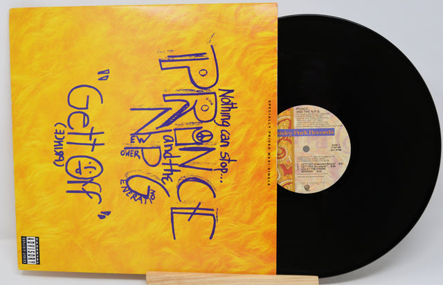 Vinyl record with a yellow cover featuring text and a black record on a white background