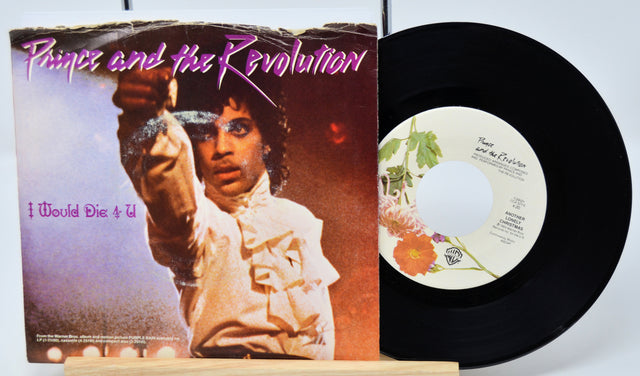 Vinyl record and cover of 'Prince and the Revolution' album on a white background