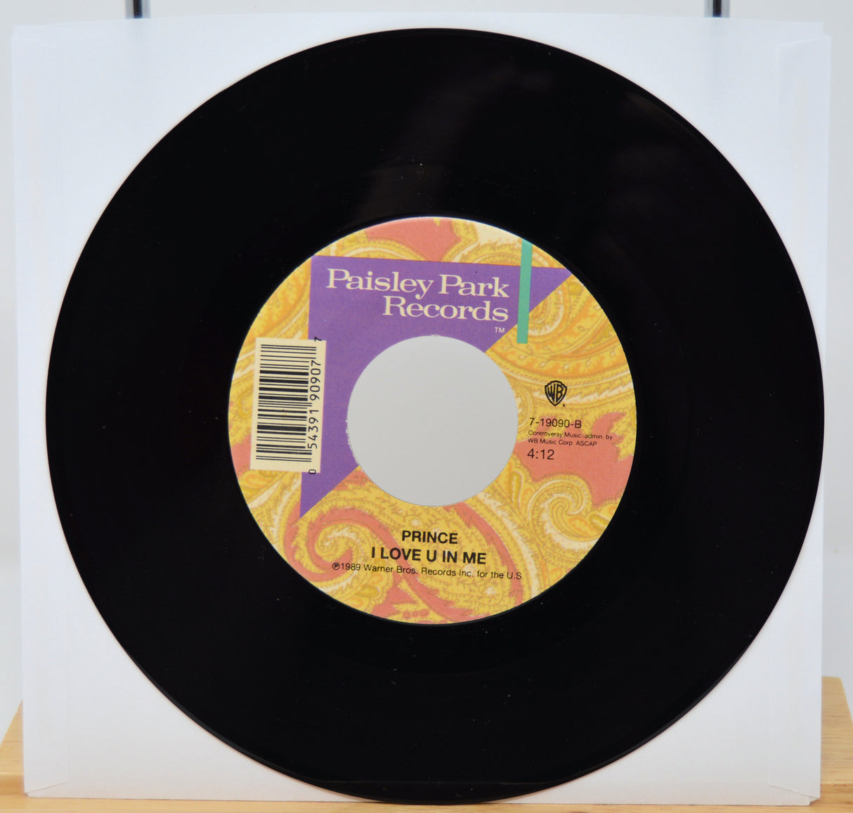 Vinyl record with a colorful label featuring 'Paisley Park Records' on a white background