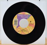 Vinyl record with a colorful label featuring 'Paisley Park Records' on a white background