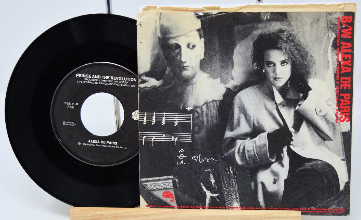 Vinyl record and its cover featuring a black and white portrait of a woman and a man.