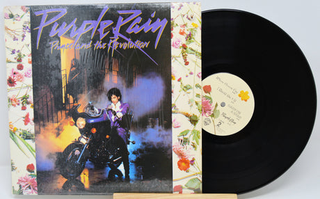 Vinyl record with 'Purple Rain' album cover featuring a motorcycle and floral design.