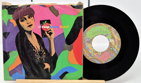 Vinyl record with colorful cover featuring a person and psychedelic design.