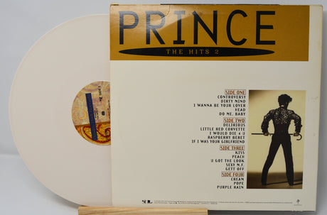 Back cover and white vinyl record of Prince – The Hits 2 showing tracklist and album artwork