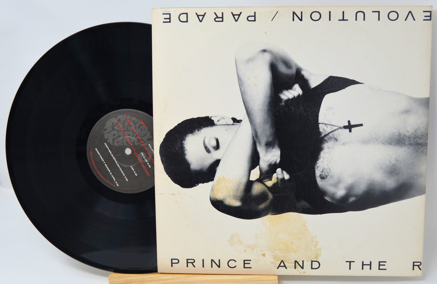 Parade album front cover featuring Prince and The Revolution with vinyl partially visible