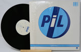 Vinyl record and its cover with a blue and white logo on a light gray background