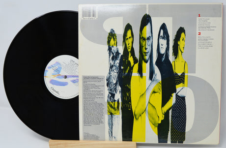 Vinyl record with a colorful cover featuring four people.
