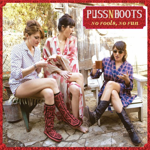 Three women sitting outdoors with 'Puss N Boots' album cover text.