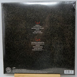 The back cover of a vinyl record album in shrink wrap, showing track listings for Samh A and Samh B in red and white text over a dark textured background.