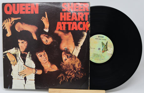 Vinyl record with 'Sheer Heart Attack' by Queen on a white background