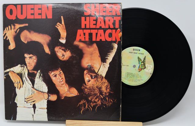 Vinyl record with 'Sheer Heart Attack' by Queen on a white background