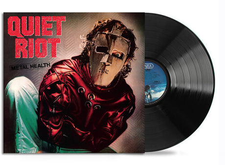 Vinyl record with 'Quiet Riot' album cover featuring a person in a red outfit and helmet.